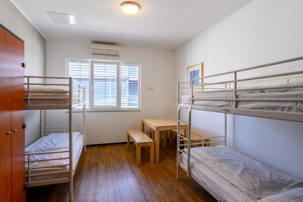 white bunk beds in white hotel room