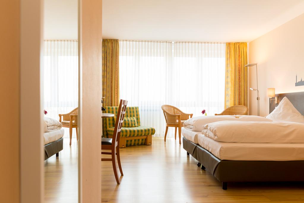 large hotel room with bed and seating area