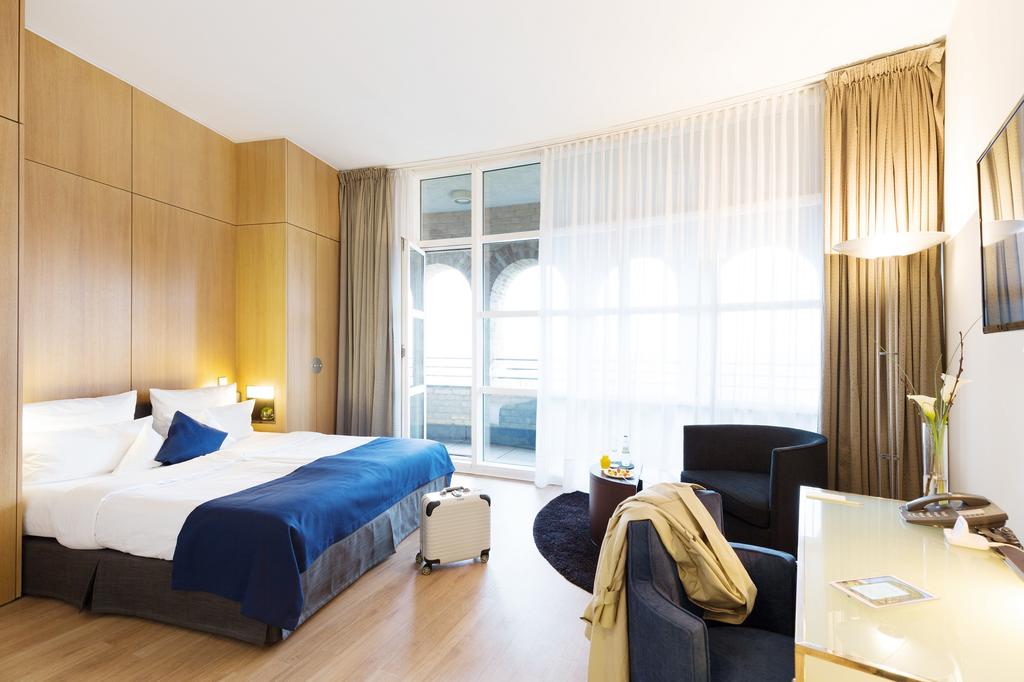 large hotel room with doors leading to balcony