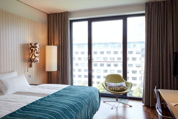 beige and blue hotel room with wall of glass