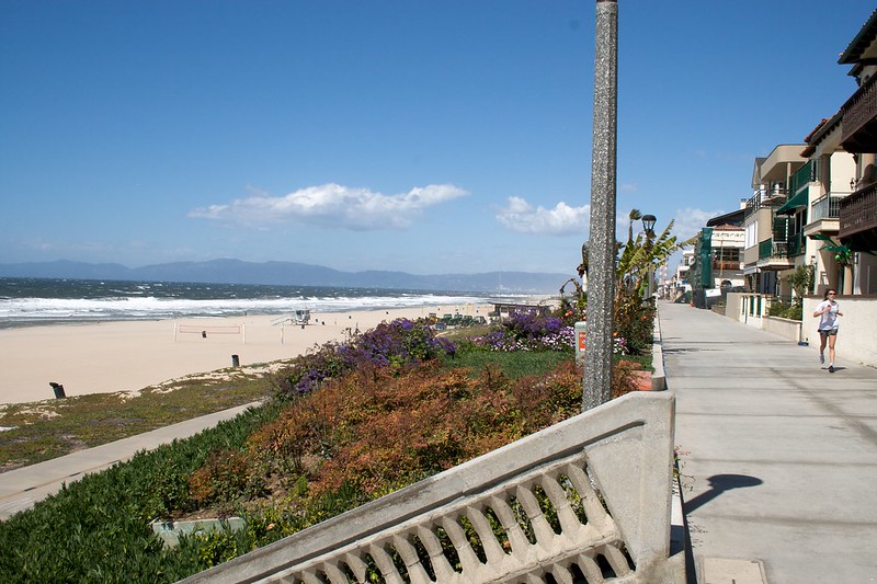 person running on path near beach
