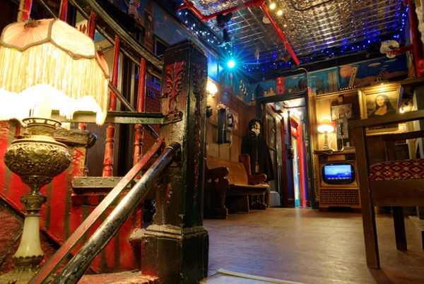 Carlton Arms Hotel lobby filled with old art and antique furnishings