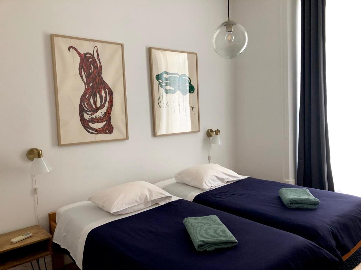 blue bed with art hanging above bed in hotel room at Living Lounge Hostel