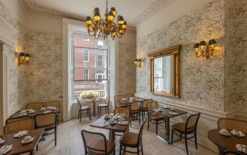 ornate dining room with vintage wood tables and chairs
