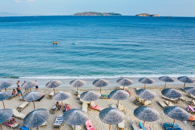 beach chairs and umbrellas on beach in Greece
