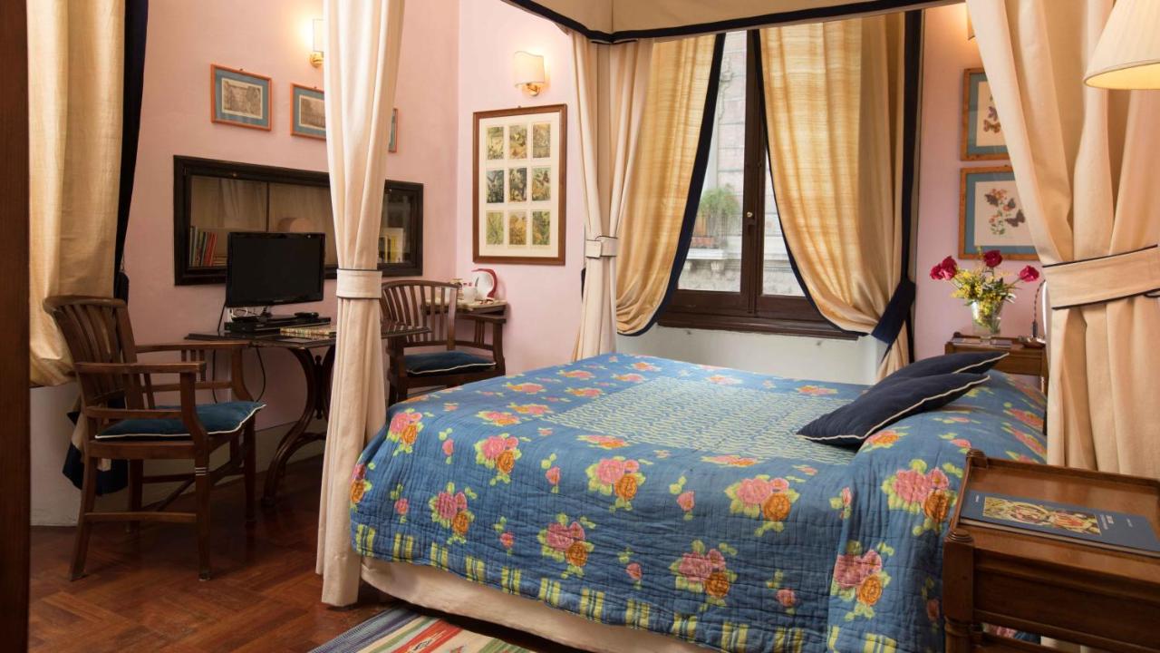 canopy bed with blue floral quilt in budget hotel Residenza Johanna I