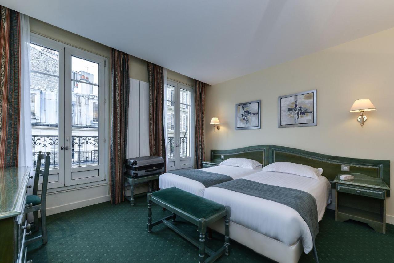green and white bed in hotel room in Paris