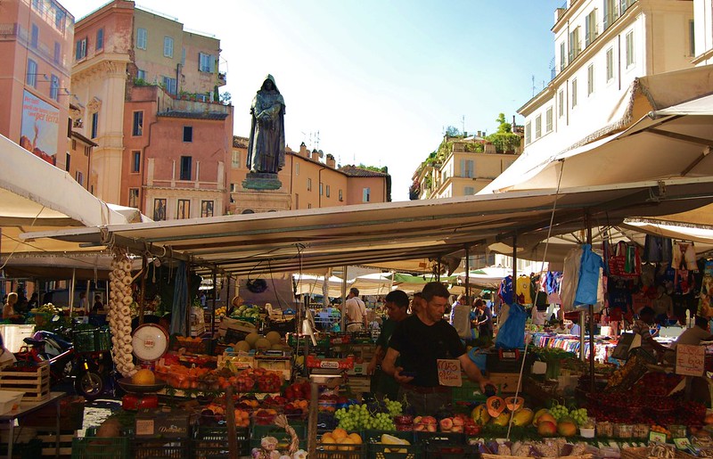 vendor setting up produce at Campo de' Fiori Market in Rome